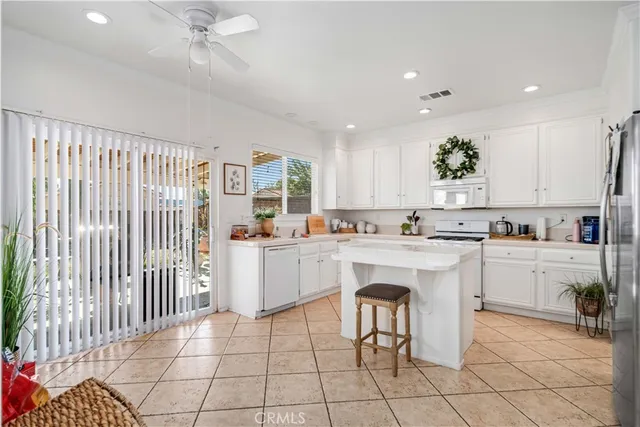 a kitchen with white cabinets and white appliances