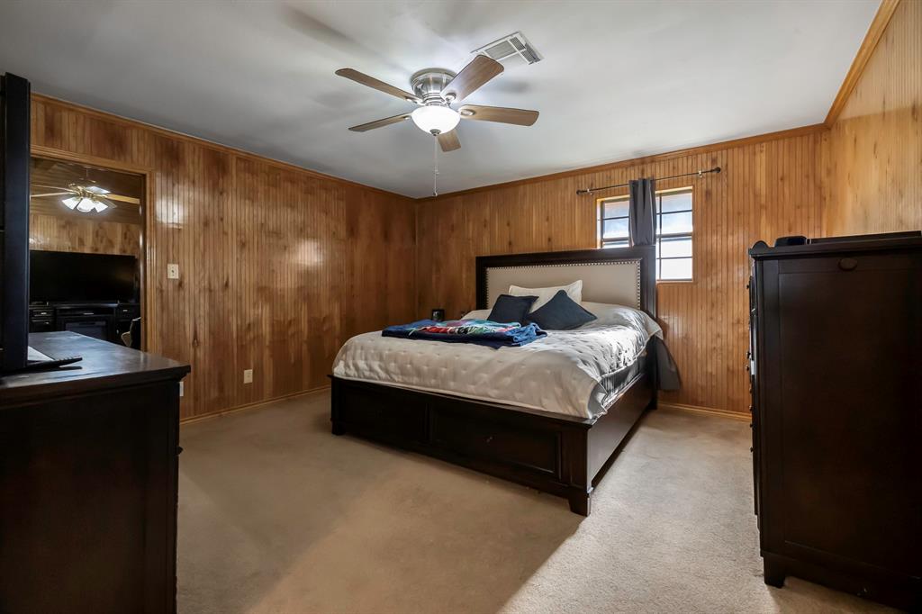 232 South Moseley Street De Leon, TX 76444 - Photo 13 of 39 a bedroom with a bed dresser and a large window