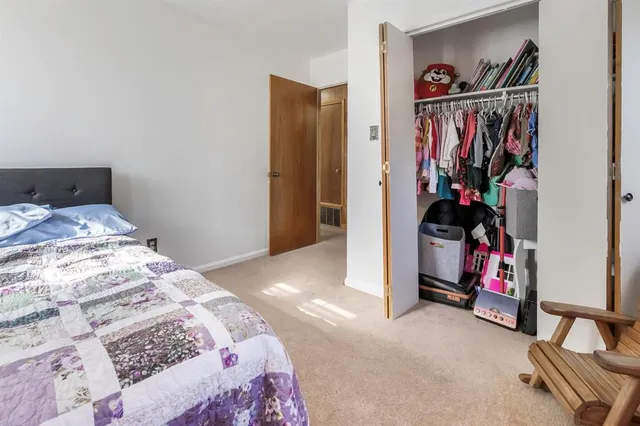 a bedroom with a bed and a view of bedroom