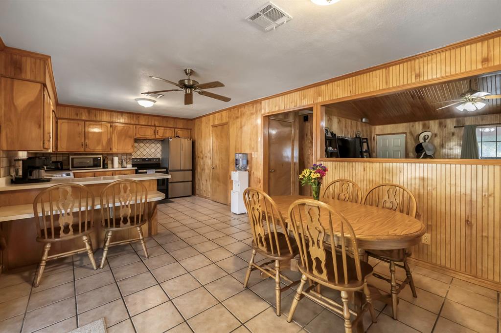 232 South Moseley Street De Leon, TX 76444 - Photo 9 of 39 a dining area with furniture and a chandelier