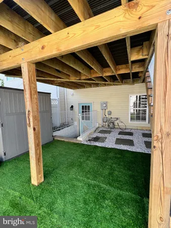a view of a backyard with plants and a patio