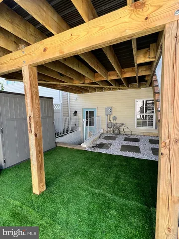a view of a backyard with plants and a patio