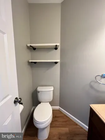 a white toilet sitting next to a bathroom sink
