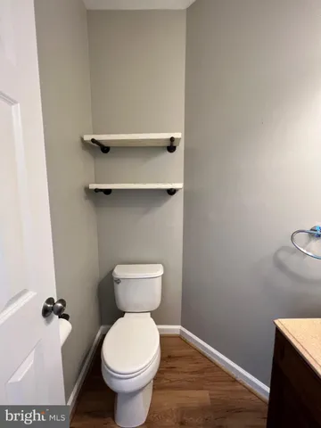 a white toilet sitting next to a bathroom sink