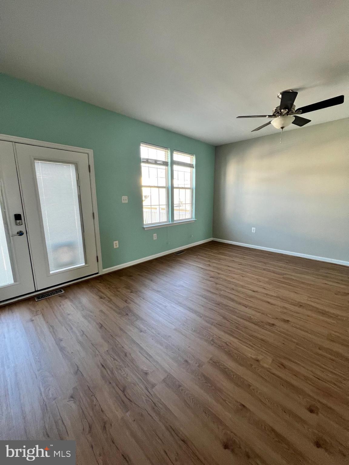 66 Davis Street Charles Town, WV 25414 - Photo 35 of 45 an empty room with wooden floor fan and windows