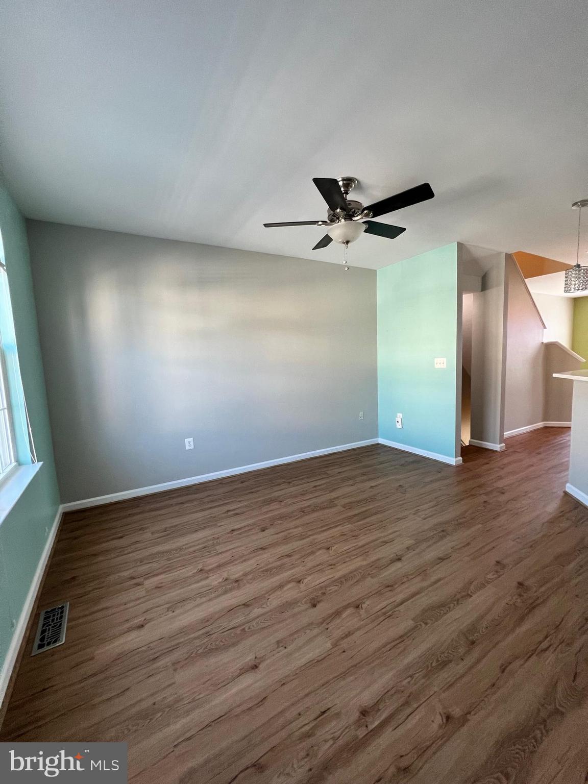66 Davis Street Charles Town, WV 25414 - Photo 37 of 45 an empty room with wooden floor and a ceiling fan