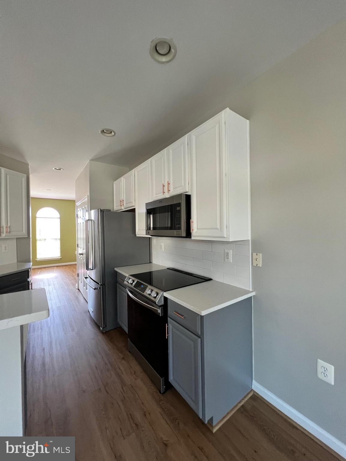 66 Davis Street Charles Town, WV 25414 - Photo 39 of 45 a kitchen with granite countertop a stove top oven a sink dishwasher and a refrigerator with wooden floor