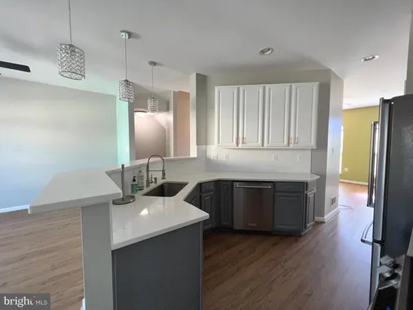 a kitchen with a sink stove and refrigerator