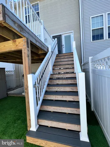 a view of entryway with wooden floor and a front door