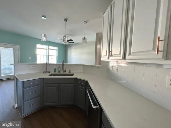 a kitchen with sink cabinets and window