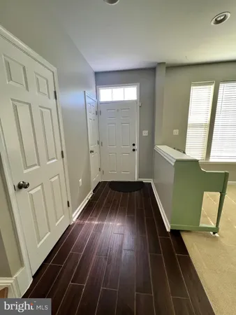 a view of a livingroom with wooden floor and stairs