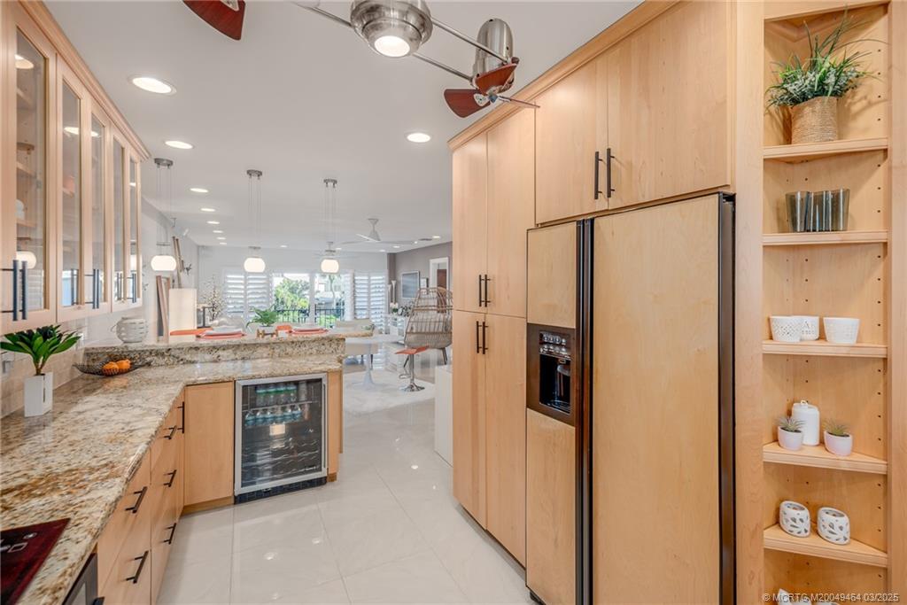 3901 Southeast St Lucie Boulevard, Unit 39 Stuart, FL 34997 - Photo 12 of 70 a kitchen with stainless steel appliances granite countertop a refrigerator a oven and a sink with cabinets