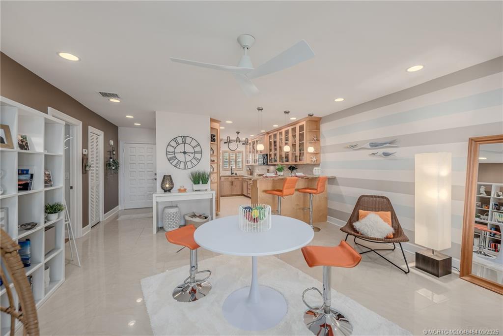 3901 Southeast St Lucie Boulevard, Unit 39 Stuart, FL 34997 - Photo 14 of 70 a living room with furniture and a chandelier