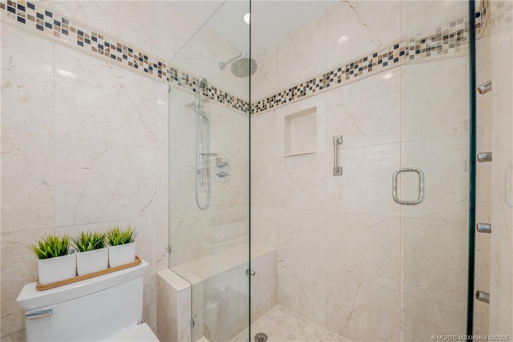 3901 Southeast St Lucie Boulevard, Unit 39 Stuart, FL 34997 - Photo 20 of 70 a bathroom with a shower a toilet and sink