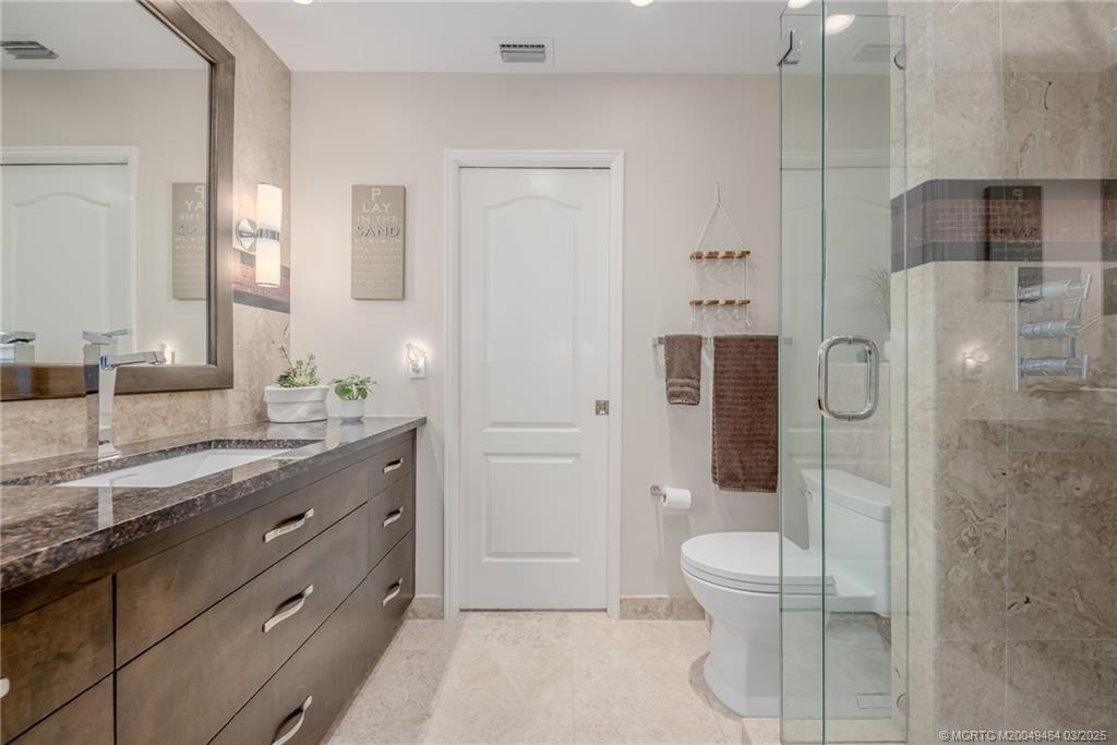 3901 Southeast St Lucie Boulevard, Unit 39 Stuart, FL 34997 - Photo 24 of 70 a spacious bathroom with a granite countertop sink a toilet and shower