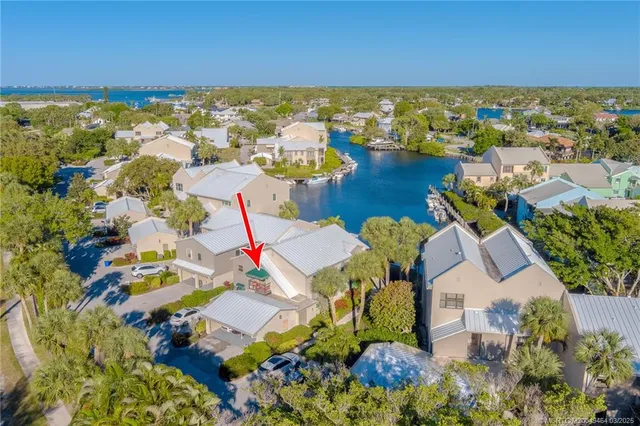 a view of a house with backyard water fountain and sitting area