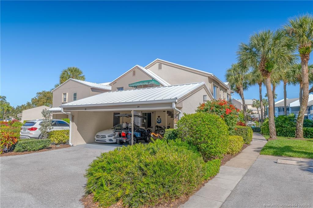 3901 Southeast St Lucie Boulevard, Unit 39 Stuart, FL 34997 - Photo 26 of 70 a front view of a house with a yard
