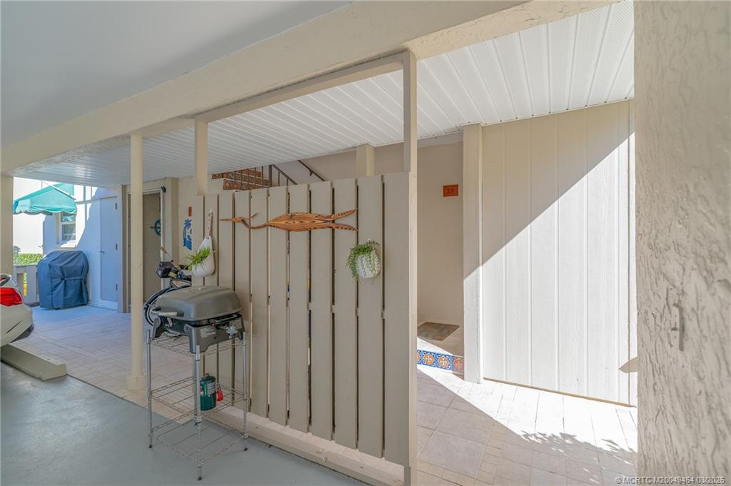 3901 Southeast St Lucie Boulevard, Unit 39 Stuart, FL 34997 - Photo 29 of 70 a view of a hallway to a livingroom with furniture and stairs