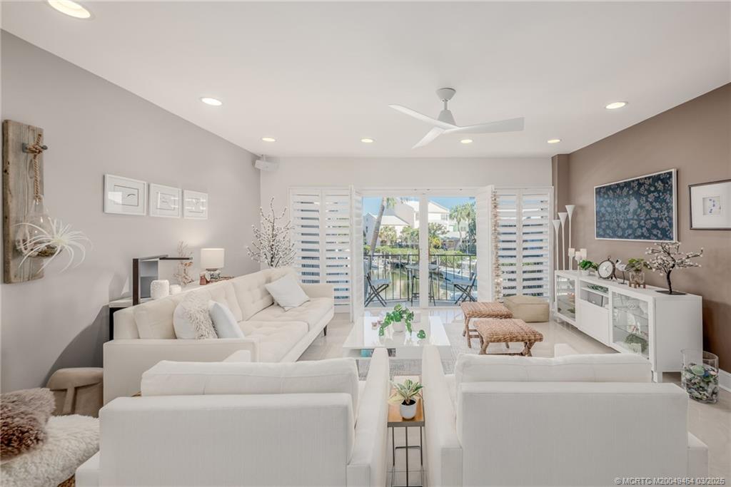 3901 Southeast St Lucie Boulevard, Unit 39 Stuart, FL 34997 - Photo 3 of 70 a living room with furniture and a large window