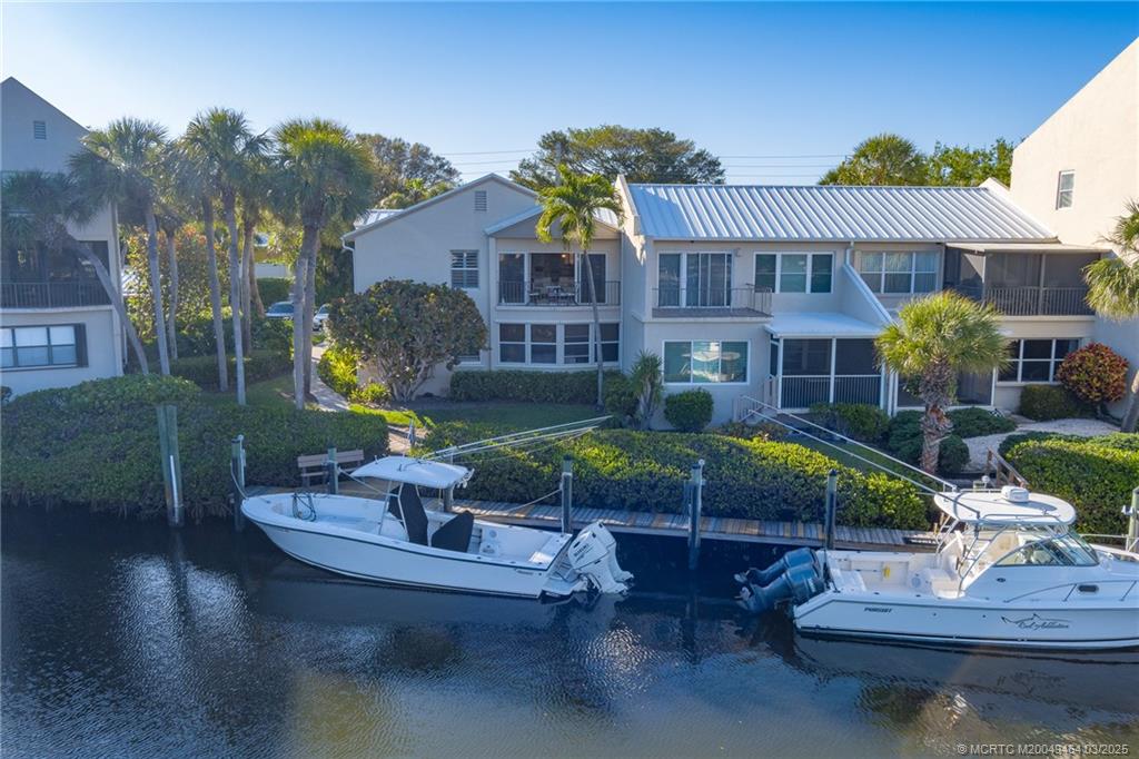 3901 Southeast St Lucie Boulevard, Unit 39 Stuart, FL 34997 - Photo 34 of 70 a view of a house with backyard water fountain and sitting area