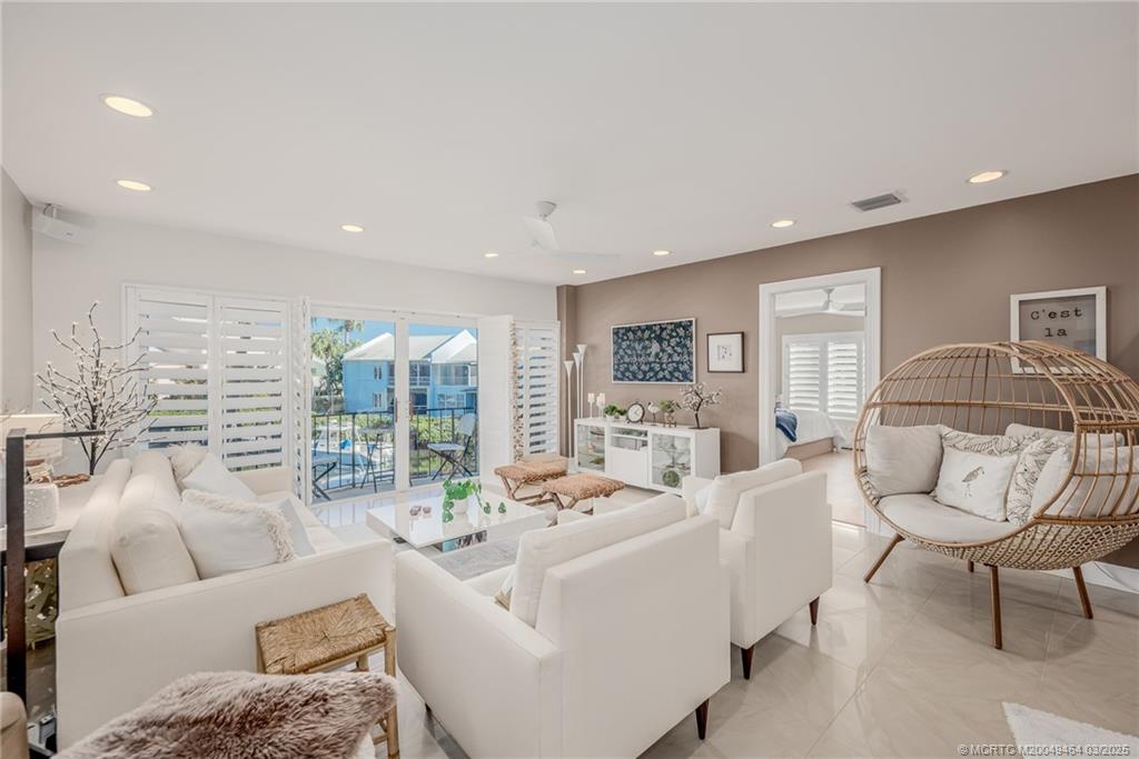 3901 Southeast St Lucie Boulevard, Unit 39 Stuart, FL 34997 - Photo 4 of 70 a living room with furniture and a large window