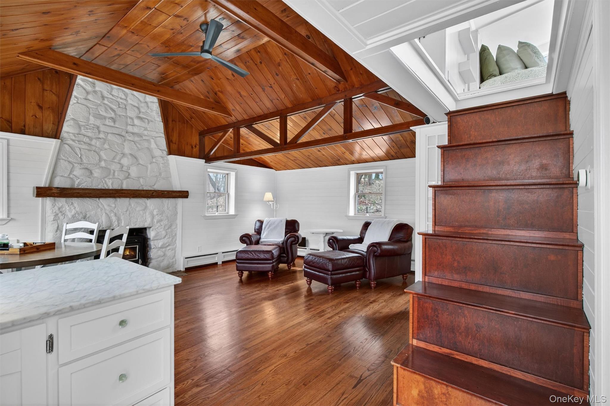 58 Oxford Springs Road Chester, NY 10918 - Photo 15 of 38 Living area featuring a high wood beamed ceiling, dark wood-style floors, a fireplace, a ceiling fan, and a baseboard radiator