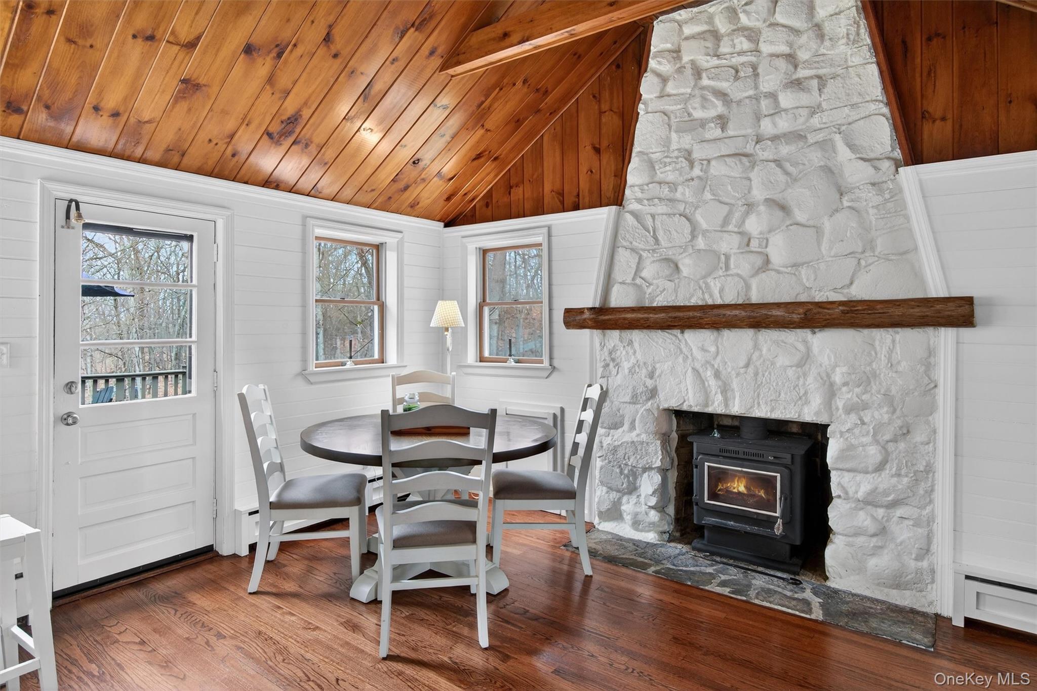 58 Oxford Springs Road Chester, NY 10918 - Photo 18 of 38 Dining area with lofted ceiling with beams, wood finished floors, wooden ceiling, wooden walls, and a baseboard radiator