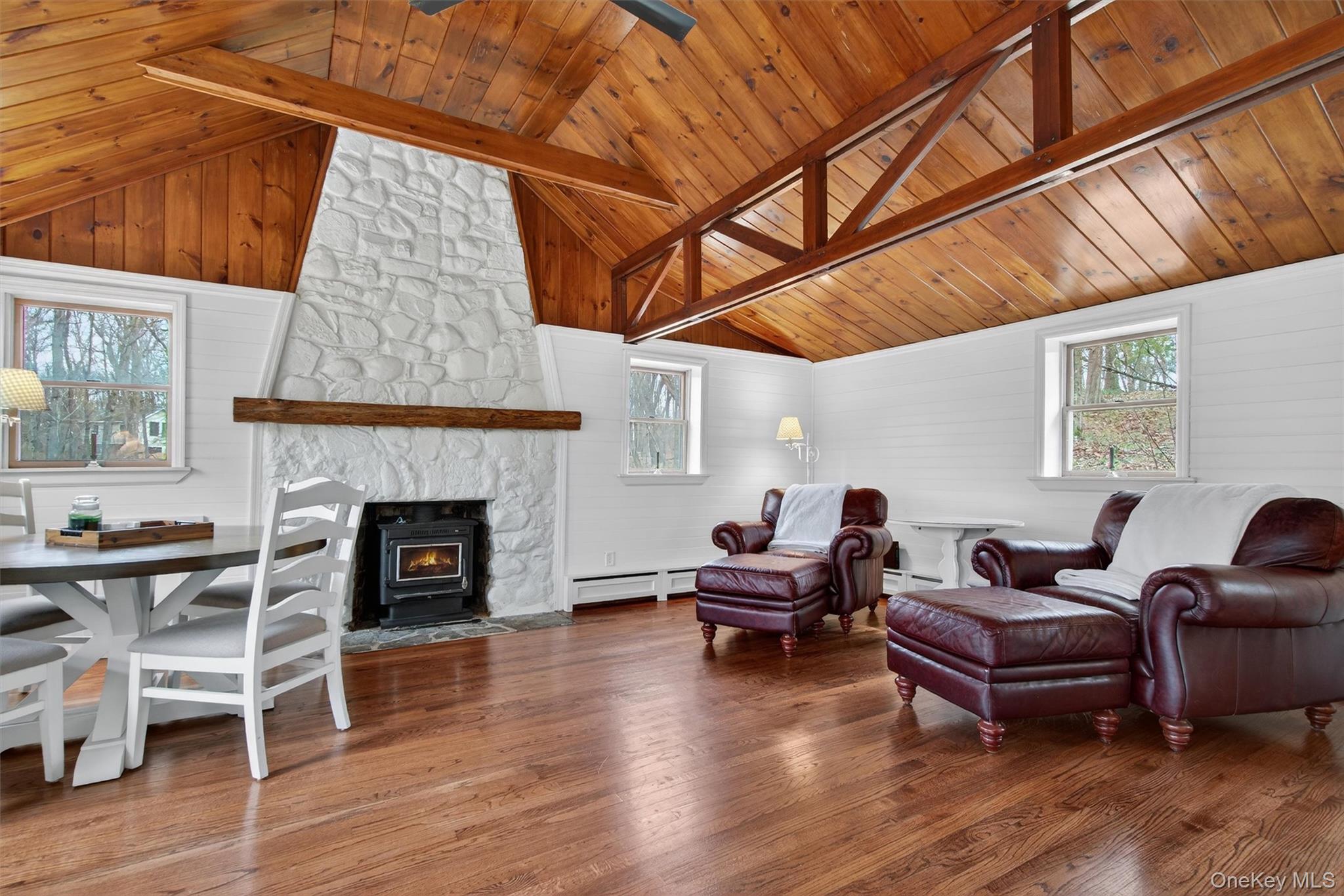 58 Oxford Springs Road Chester, NY 10918 - Photo 21 of 38 Living area with wood finished floors, a baseboard radiator, and a high wood beamed ceiling