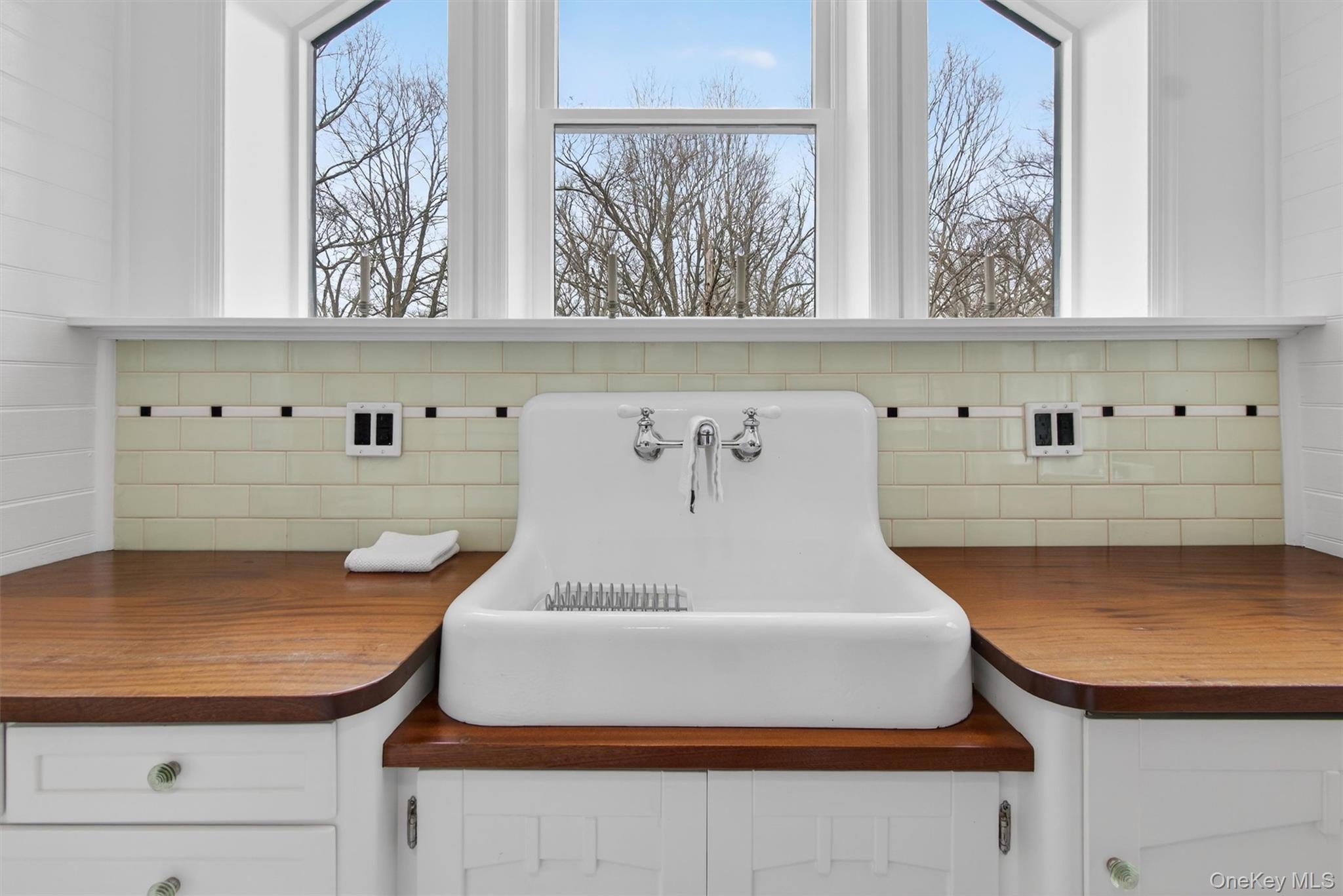 58 Oxford Springs Road Chester, NY 10918 - Photo 9 of 38 Kitchen view of white cabinets, tasteful backsplash, and wooden counters