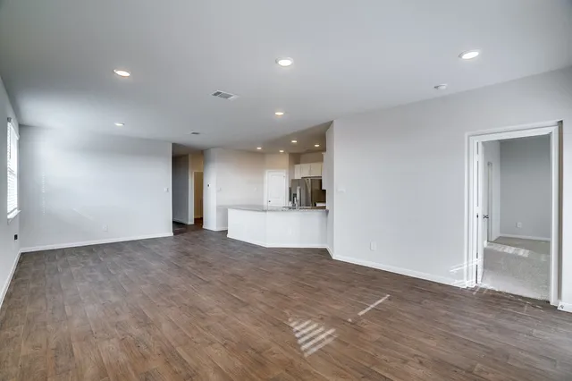a view of kitchen and hall with wooden floor