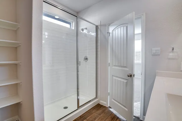 a bathroom with a glass shower door