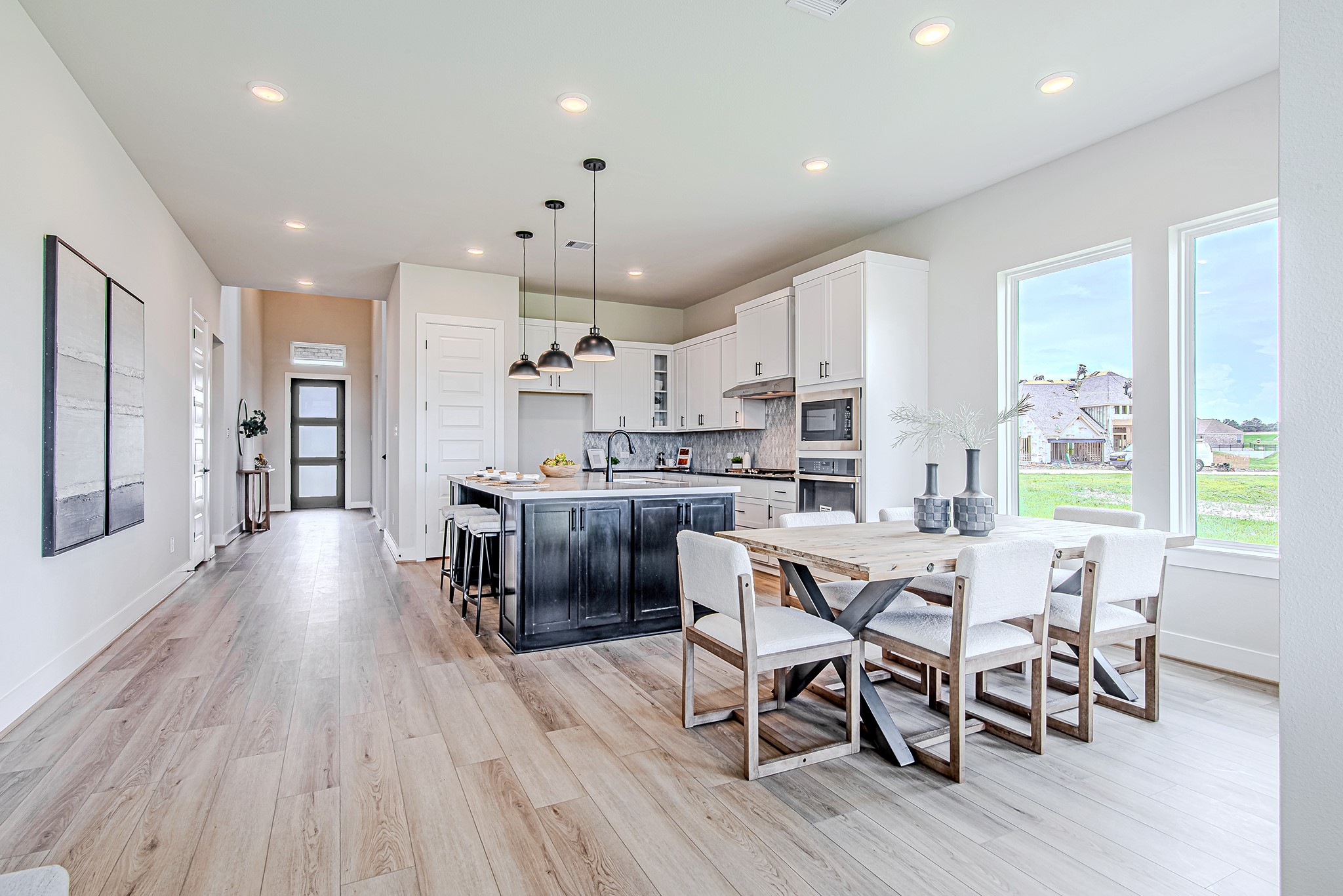 141 Peninsula Point Drive Montgomery, TX 77356 - Photo 15 of 47 Open-concept design shines in this airy space featuring a gourmet kitchen, dining area, and direct access to the backyard.