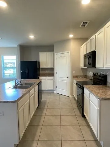 a kitchen with stainless steel appliances granite countertop a sink and a stove