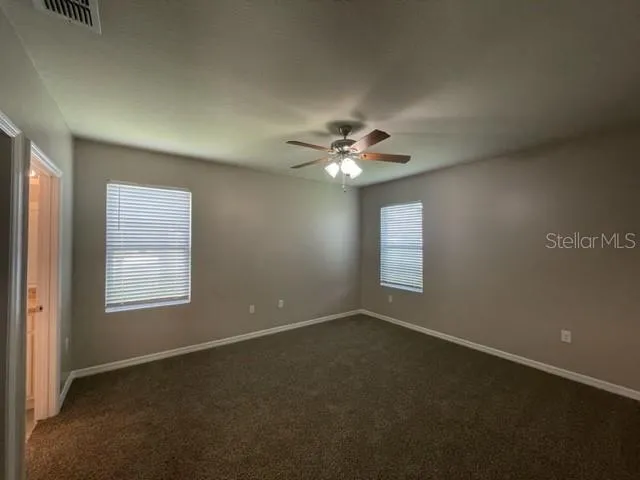 a bathroom with a granite countertop sink a toilet and a mirror
