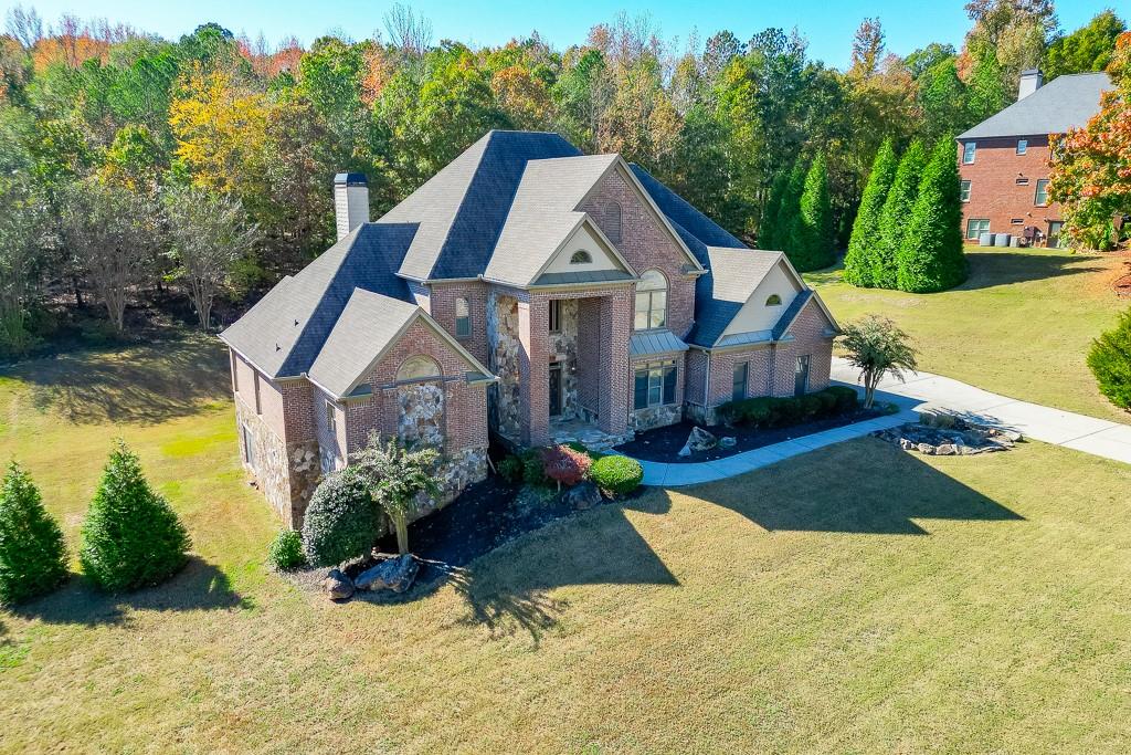 940 Chateau Forest Road Hoschton, GA 30548 - Photo 84 of 87 a front view of a house with a yard and trees