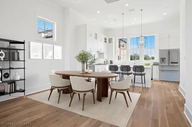 a view of a dining room with furniture and wooden floor