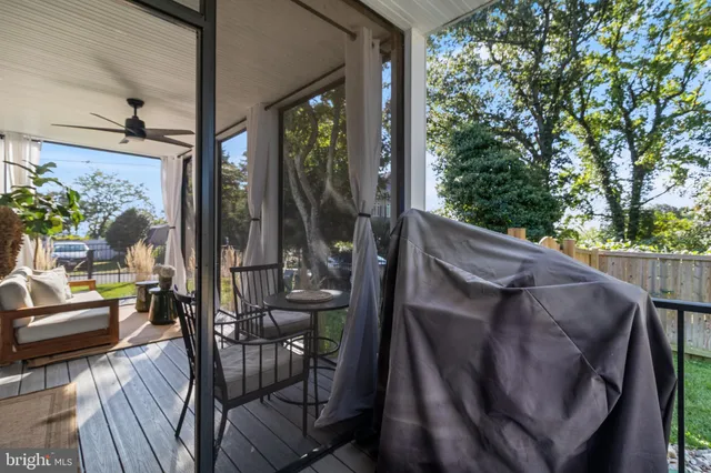 a view of balcony with chairs and wooden fence