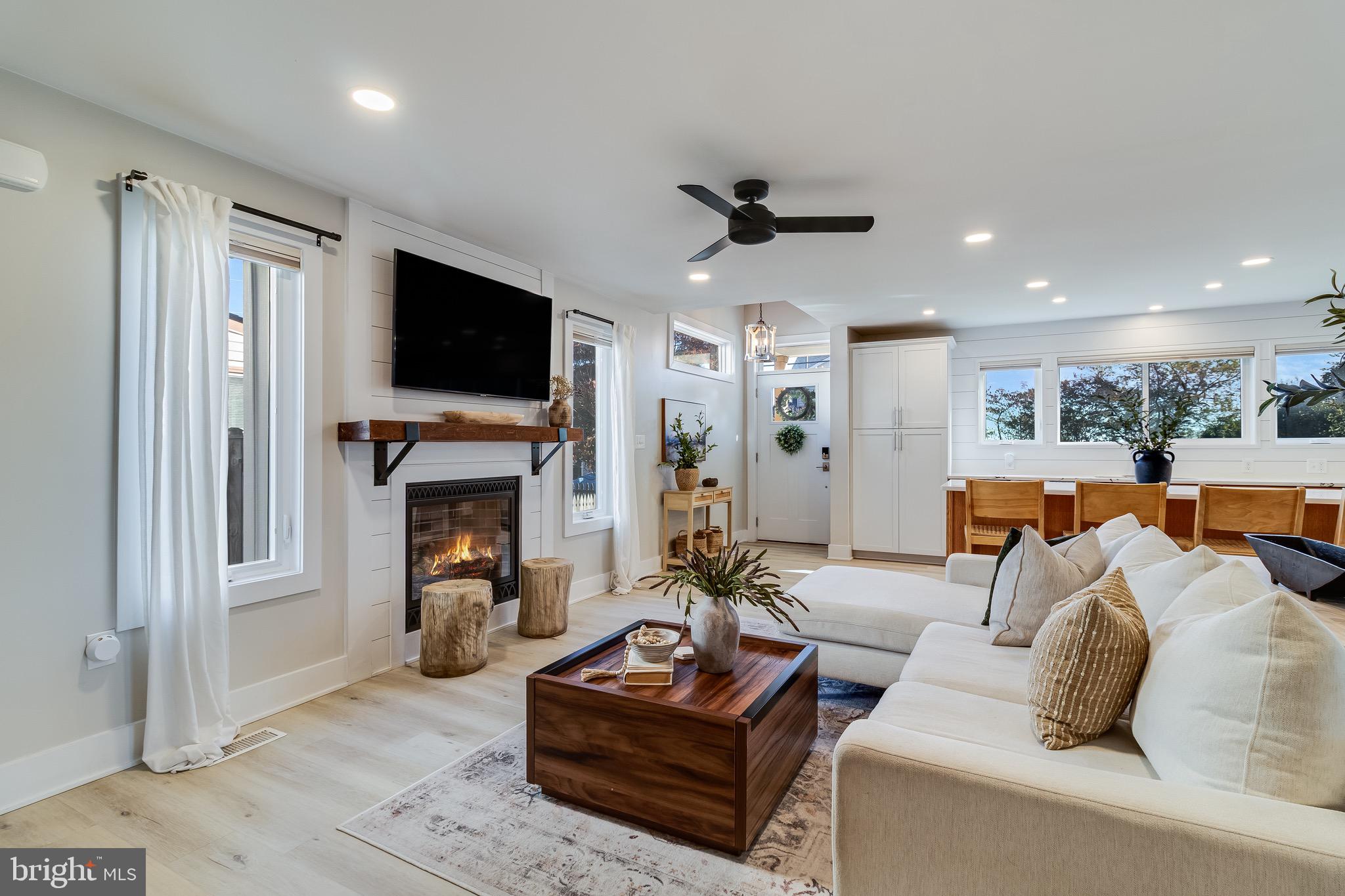 84 Chesapeake Avenue Prince Frederick, MD 20678 - Photo 15 of 42 a living room with furniture a fireplace and a flat screen tv