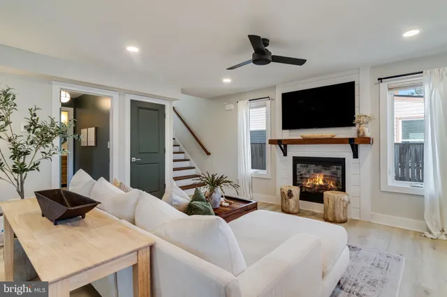 a living room with furniture fireplace and flat screen tv