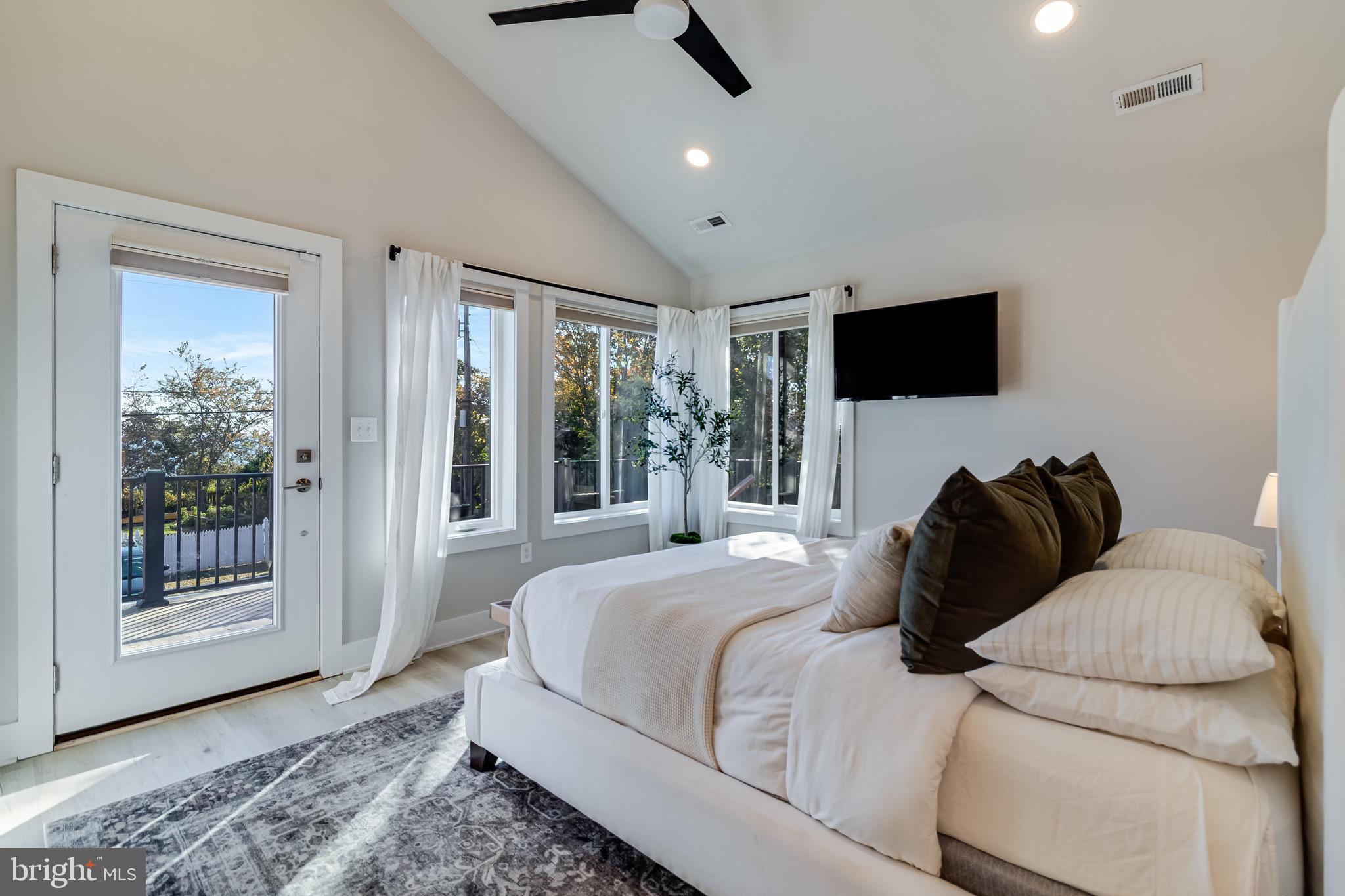 84 Chesapeake Avenue Prince Frederick, MD 20678 - Photo 21 of 42 a bedroom with a bed a flat screen tv and a couch