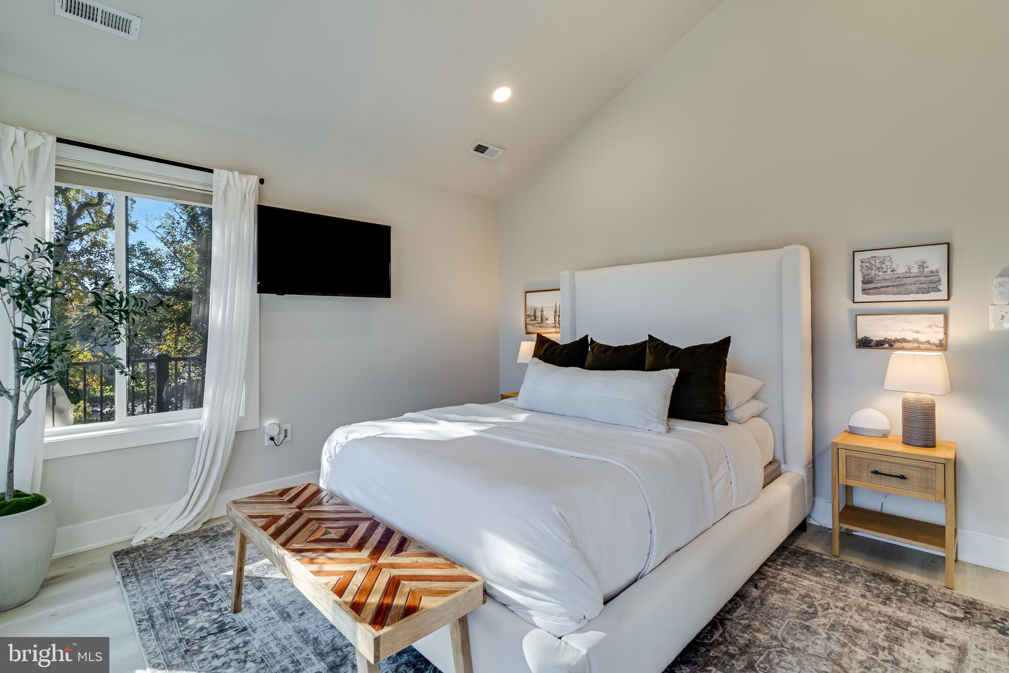 84 Chesapeake Avenue Prince Frederick, MD 20678 - Photo 22 of 42 a bedroom with a bed a flat screen tv and a couch