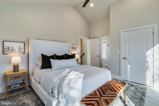 a large bed sitting in a bedroom and a table