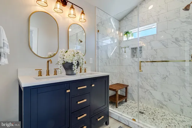 a bathroom with a double vanity sink mirror and shower