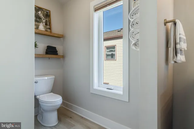 a white toilet sitting next to a bathroom sink