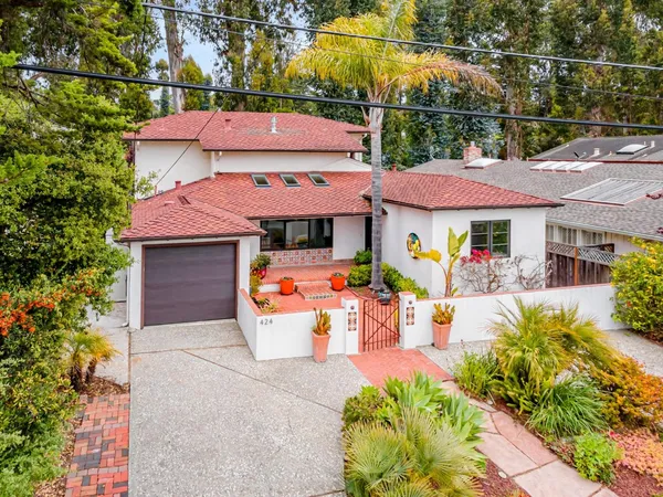 an aerial view of a house with garden space and street view