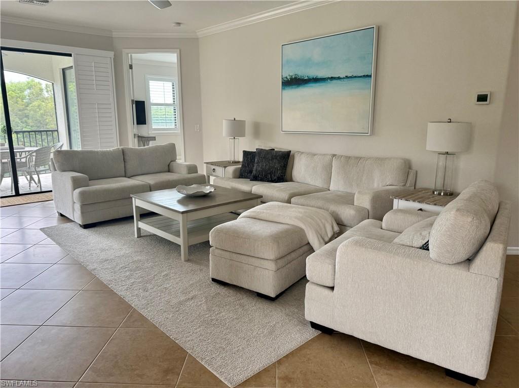 9498 Napoli Lane, Unit 201 Naples, FL 34113 - Photo 11 of 48 a living room with furniture and a large window