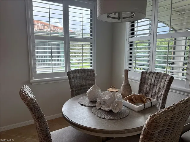 a dining room with furniture and window