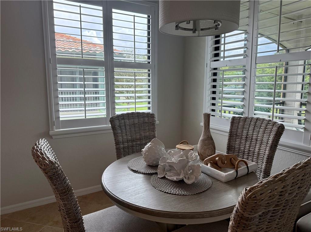 9498 Napoli Lane, Unit 201 Naples, FL 34113 - Photo 16 of 48 a dining room with furniture and window
