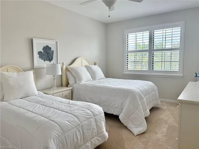 a bedroom with bed and a window