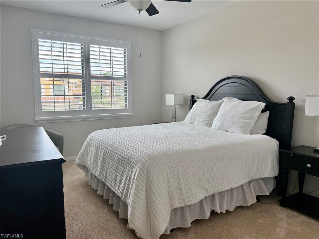 9498 Napoli Lane, Unit 201 Naples, FL 34113 - Photo 22 of 48 a bedroom with a bed and a window